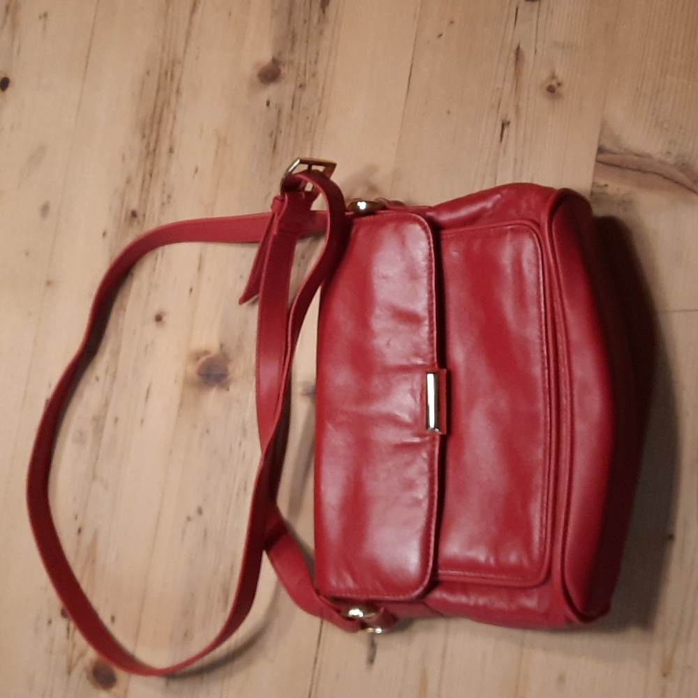 Red bag with gold clasp. No brand. Used but good condition.